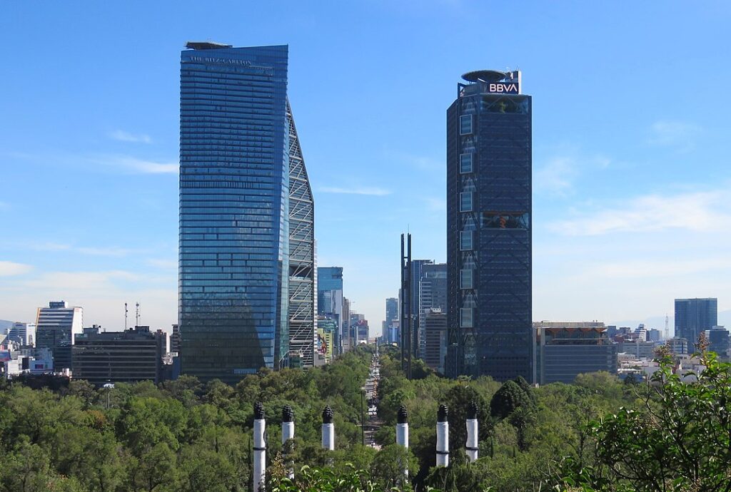 Breath-taking panoramic view of Paseo de la Reforma as seen from the elevated perspective of Chapultepec Castle, a fusion of natural beauty, historic architecture, and modern urban development.