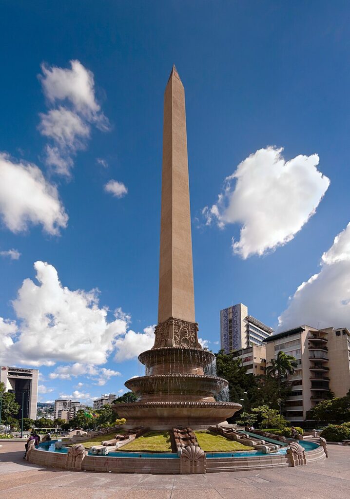 A magnificent view of the iconic Obelisco de la Plaza Francia, a prominent landmark in Caracas, Venezuela, standing tall against a clear sky.