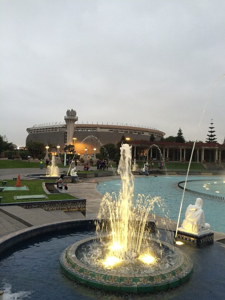 Illuminated water fountains dancing amidst the verdant setting of Parque de la Reserva in downtown Lima.